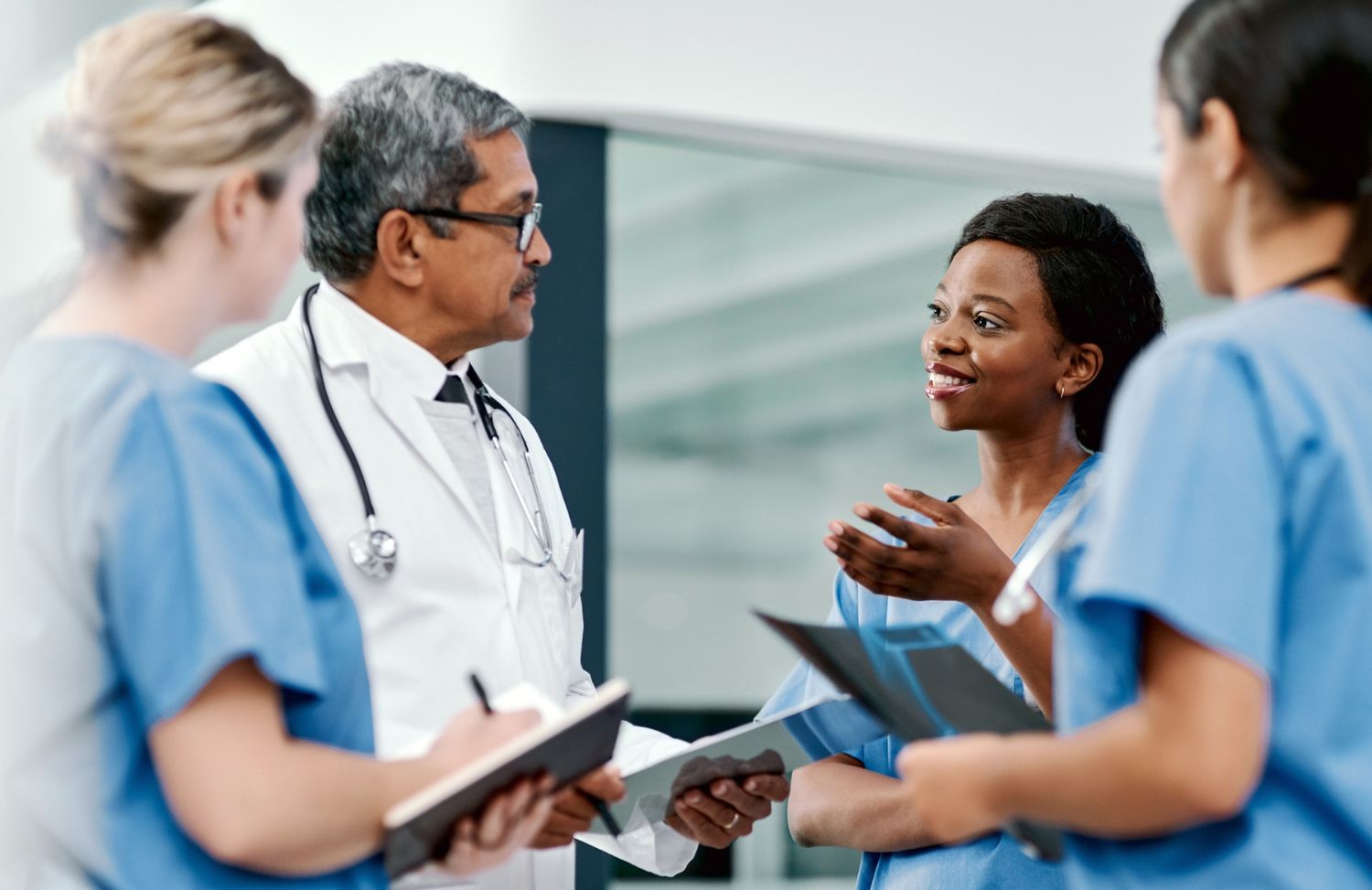 Chiropractor consulting with care team